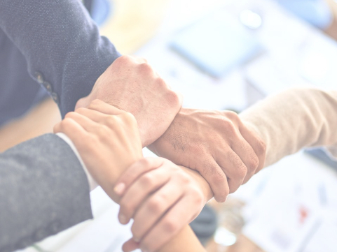 Hands united to show our strategic connection to Wolters Kluwer.